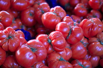 Paris, France - May 18, 2025: Colorful fresh tomatoes sold at Marche or open-air market in Paris
