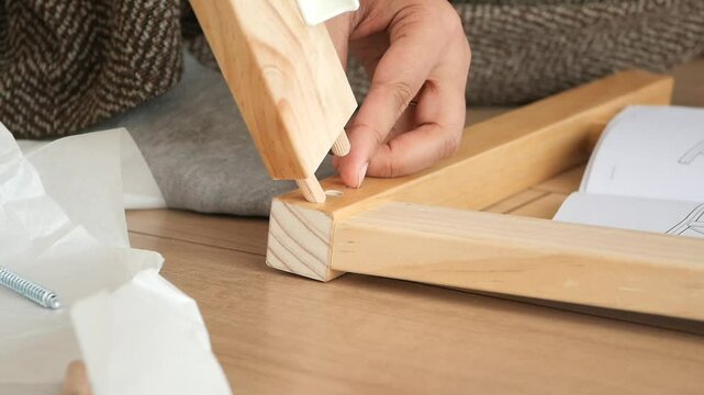 Assembling wooden furniture using simple tools at home