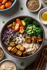 Tempeh grain bowl with roasted vegetables wild rice and creamy tahini dressing
