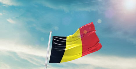 Belgium national flag waving with beautiful sky. 