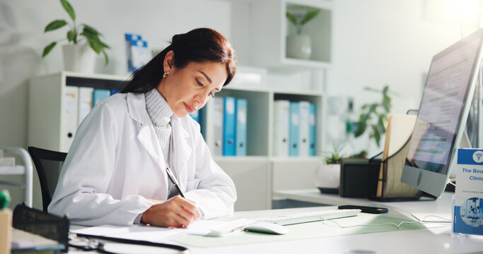 Computer, woman and doctor writing report in clinic for research, diagnosis or treatment. Tech, medical service and female healthcare worker with referral document for paperwork in hospital office
