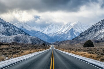 Naklejka premium A paved road winds through a wintry mountain pass