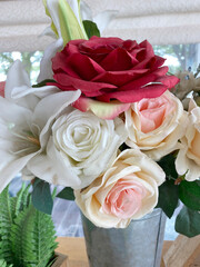 beautiful bouquet of roses in a vase on a white background
