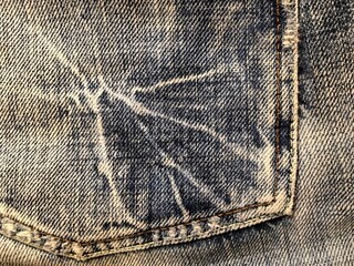 Worn-out distressed blue denim fabric texture