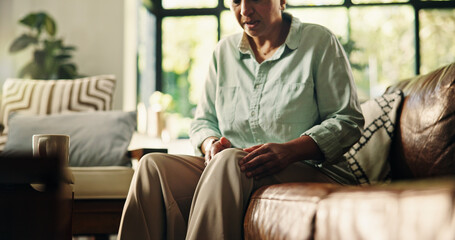Knee pain, injury and senior woman in home for .osteoporosis, leg joint and emergency. Arthritis cramp, mobility risk and anatomy with hurt mature female person in house living room for fibromyalgia
