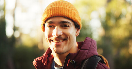 Happy, hiking and portrait of man in nature for trekking, adventure and wilderness explore. Eco tourism, backpacking travel and journey with person in forest for vacation, peace and wellness trip