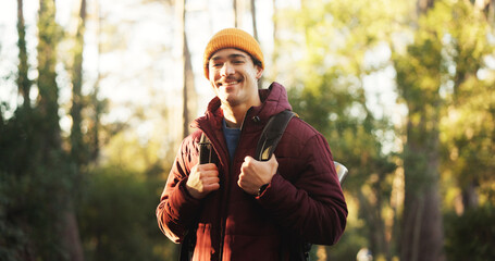 Smile, hiking and portrait of man in nature for trekking, adventure and wilderness explore. Eco tourism, backpacking travel and journey with person in forest for vacation, peace and wellness trip