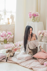 A brunette woman stands quietly in the morning light, wrapped in a sheer white vintage gown, ...