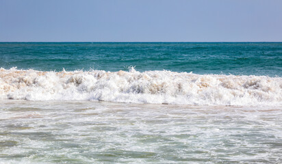The ocean is calm and the waves are small