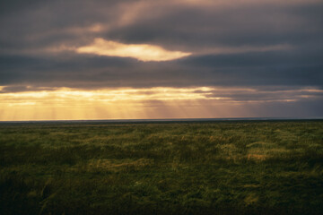 Countryside view with sun light ray with cloudy with grass field in iceland.