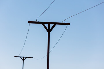 Two power lines are connected to a pole
