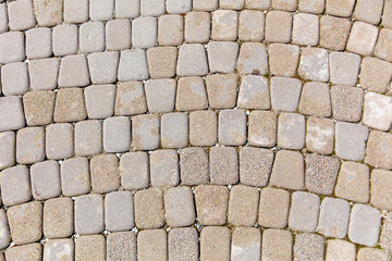 A brick patterned floor with a gray and tan color scheme