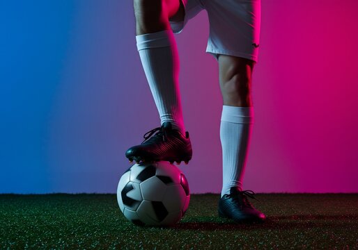 Soccer Player with Ball Under Neon Lights (2)