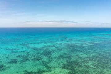 Tropical seascape with blue sea surface with coral reefs in Bantayan, Cebu. Philippines.