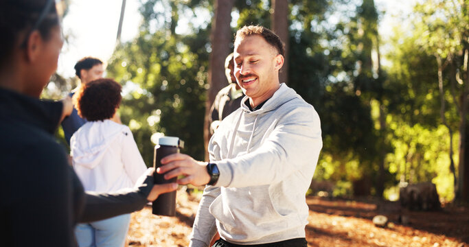 Marathon, man and share water in forest for fitness, workout and endurance for health. Cardio club, running group and hydration break for competition, practice and team exercise for training together - Powered by Adobe