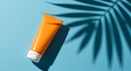 Orange Sunscreen Tube on Blue Background with Palm Leaf Shadow (7)