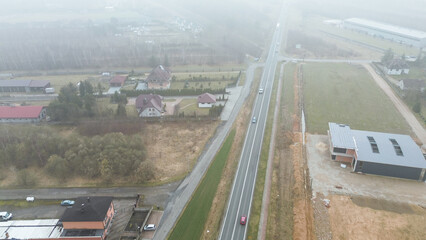Empty rural street on foggy day