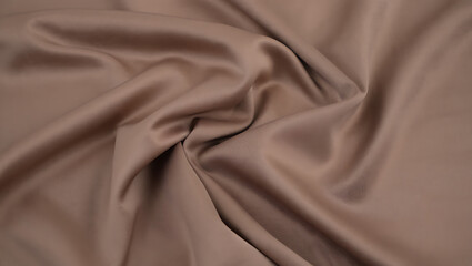Fototapeta premium Draped taupe brown satin fabric texture