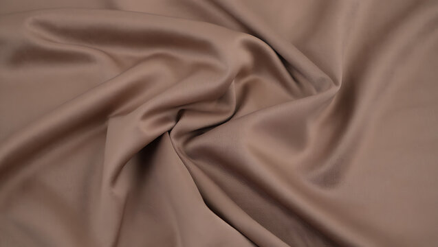 Draped taupe brown satin fabric texture