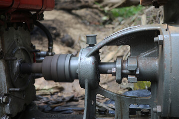 Extended shaft of a centrifugal water pump connected to diesel engine. Diesel motor shaft
