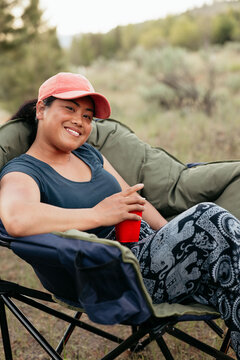 Camper relaxing in folding chair enjoying camping trip