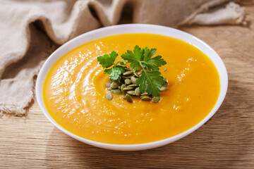 plate of pumpkin soup with parsley and seeds