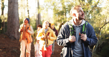 Hiking, nature and man with friends with adventure, journey or activity on outdoor vacation. Walking, woods and people with trekking together for hobby, exploring or travel in forest on holiday.