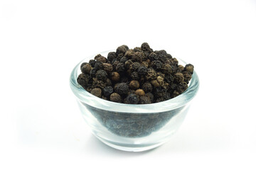 Pepper seeds in a cup placed on a white background.