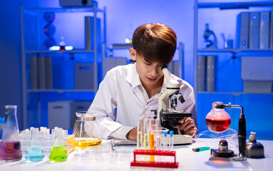 Young Scientist Engaged in Microscope Research in Laboratory Setting