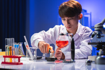 Young Scientist Conducts Experiment with Lab Equipment and Glassware