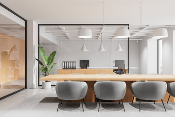 Modern conference room with gray chairs, wood table, and glass walls in bright minimalist office interior with pendant lights and potted plant decor. 3D Rendering