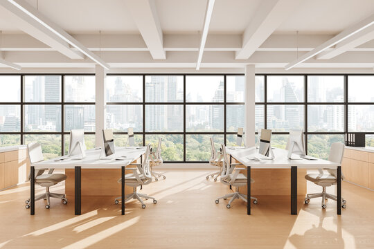 Modern open space office interior with minimalist design, large windows, white desks, and cityscape view in daylight. 3D Rendering. 3D Rendering