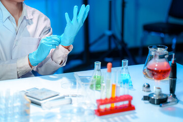 Fototapeta premium Laboratory Scientist Preparing for Experiment with Protective Gloves