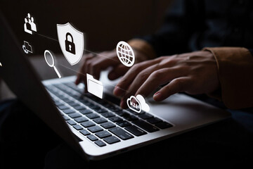 Person using laptop with digital security icons displayed