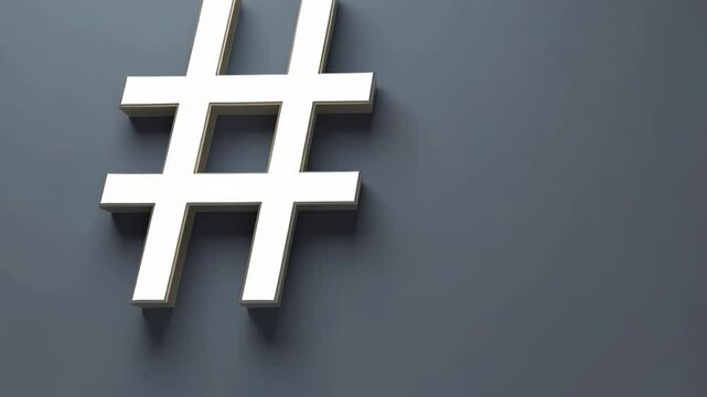 Hashtag symbol made from gold color, placed on a dark gray background in a studio setting.