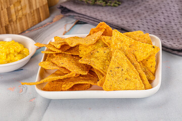 Corn nachos chips with cheese dip