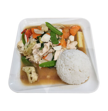 Capcay rice in a white square plate, consisting of various fresh vegetables such as carrots, mustard greens, cauliflower, broccoli, mushrooms, and green beans.
Chinese food, restaurant cuisine.