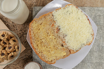 Bread with cheese, sweetened condensed milk, and butter. With white milk and snack on a table for breakfast