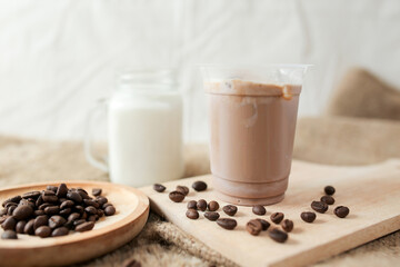 Delicious iced coffee, mocca, and chocolate drinks with coffee beans on white wooden table