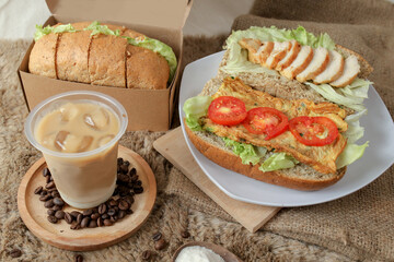 Big breakfast, bread, chicken slice, tomato, lettuce, smoked beef, egg, salad with milk. Bread sandwich fresh and healthy food meal lunch dinner breakfast slices of sandwiches.