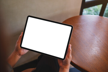 Mockup image of a woman holding digital tablet with blank white desktop screen