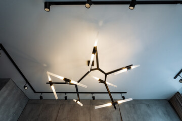 A beautiful chandelier is elegantly hanging from the ceiling in a stunning room, adding a touch of...