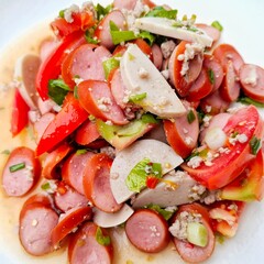Delicious Sausage Salad: A vibrant shot of a tantalizing sausage salad, artfully composed with sliced sausages, fresh tomatoes, herbs, and a flavorful dressing, representing a culinary delight.