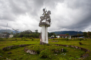 A statue of an equestrian hero in traditional clothing in Municipal Ainaro, symbolizing the heroism...
