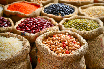 Variety of Grains and Legumes in Burlap Sacks at a Market