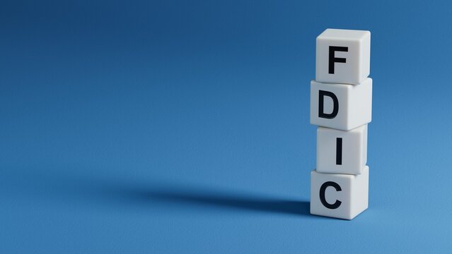 fdic word written on wooden elements with copy space.close up of wooden elements,Business Concept.3D rendering on blue background.