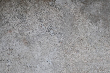 Detailed view of a gray concrete surface with textures and wear