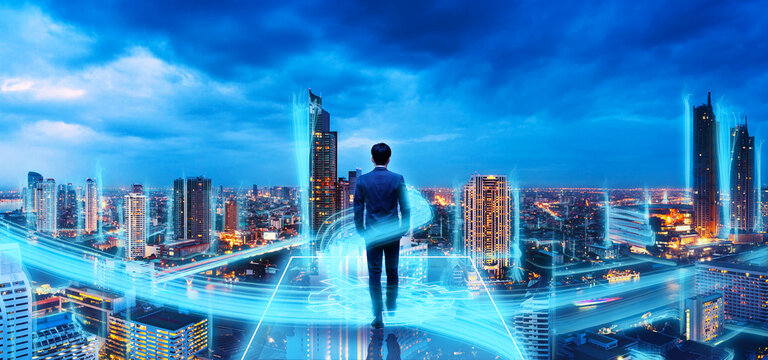 Professional business man on future technology network iot smart city background at night in Bamgkok Thailand