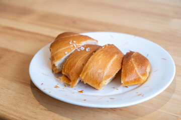 Sliced salted bread served on plate, on the wooden table