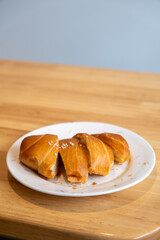 Sliced salted bread served on plate, on the wooden table